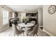 Open dining area with seating for four, featuring modern decor and a view into the kitchen at 10248 Noble Ct, Indianapolis, IN 46234