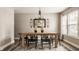 Elegant dining area with a wooden table, modern chandelier, and large windows for natural light at 10248 Noble Ct, Indianapolis, IN 46234