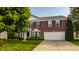 Charming two-story brick home with a well-manicured lawn and a two-car garage at 10248 Noble Ct, Indianapolis, IN 46234