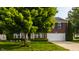 Beautiful brick home featuring a manicured lawn, mature trees, and an attached two-car garage at 10248 Noble Ct, Indianapolis, IN 46234