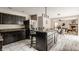 Bright and airy kitchen with dark cabinetry, stainless steel appliances, and an eat-in island at 10248 Noble Ct, Indianapolis, IN 46234