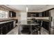 Modern kitchen with stainless steel appliances, granite countertops, and dark wood cabinetry at 10248 Noble Ct, Indianapolis, IN 46234