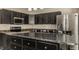 Spacious kitchen features dark cabinetry, stainless steel appliances, and an island with granite countertops at 10248 Noble Ct, Indianapolis, IN 46234