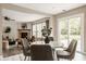 Inviting living space open to the dining area, featuring a stone fireplace and large windows at 10248 Noble Ct, Indianapolis, IN 46234