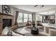 Cozy living room with a stone fireplace, modern furniture, and lots of natural light at 10248 Noble Ct, Indianapolis, IN 46234
