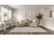 Cozy sitting area with neutral tones, comfortable armchairs, and natural light from the window at 10248 Noble Ct, Indianapolis, IN 46234
