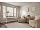 Comfortable sitting area with stylish armchairs, a console table, and a view of the outdoors at 10248 Noble Ct, Indianapolis, IN 46234