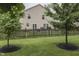 Well-maintained backyard with a wooden fence, lush lawn, and mature trees at 10510 Mcclain Dr, Brownsburg, IN 46112