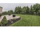 Lush backyard with a well-manicured lawn, patio, and an enclosing fence at 10510 Mcclain Dr, Brownsburg, IN 46112