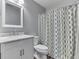 Bathroom featuring a white vanity, marble countertop, toilet, and shower with patterned curtain at 10510 Mcclain Dr, Brownsburg, IN 46112
