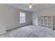 Neutral bedroom with a large window, soft carpet, and a cube storage unit at 10510 Mcclain Dr, Brownsburg, IN 46112