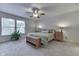 Spacious bedroom with a ceiling fan, windows, and comfortable furnishings at 10510 Mcclain Dr, Brownsburg, IN 46112