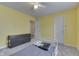 Bright bedroom features yellow walls, a ceiling fan, and a black dresser at 10510 Mcclain Dr, Brownsburg, IN 46112