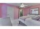 Bedroom features a ceiling fan, a bed with plush pillows, and views to the stairway at 10510 Mcclain Dr, Brownsburg, IN 46112