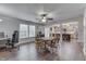 Open dining area with a wooden table, chairs, view into the kitchen, and abundant natural light at 10510 Mcclain Dr, Brownsburg, IN 46112
