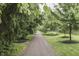 Picturesque tree-lined driveway leading to the property, surrounded by manicured lawns at 10510 Mcclain Dr, Brownsburg, IN 46112