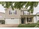 A charming two-story home featuring a two-car garage, inviting entrance, and well-manicured front yard at 10510 Mcclain Dr, Brownsburg, IN 46112