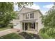 Charming two-story home features a well-maintained lawn, flower beds, and an attached two-car garage at 10510 Mcclain Dr, Brownsburg, IN 46112