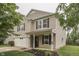 This inviting two-story home features a two-car garage, covered entryway, and colorful front garden at 10510 Mcclain Dr, Brownsburg, IN 46112