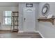 Inviting foyer with wood flooring, a decorative mirror, and convenient shelving for storage at 10510 Mcclain Dr, Brownsburg, IN 46112