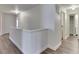 Bright hallway with hardwood floors, white walls, and views into other rooms at 10510 Mcclain Dr, Brownsburg, IN 46112