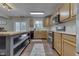 Functional kitchen featuring an island, modern appliances, and wood-look floors at 10510 Mcclain Dr, Brownsburg, IN 46112
