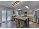 Eat-in kitchen boasts a kitchen island with stools, updated cabinets, and stainless steel appliances at 10510 Mcclain Dr, Brownsburg, IN 46112
