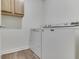 Laundry room with washer, dryer, and overhead cabinets for storage at 10510 Mcclain Dr, Brownsburg, IN 46112