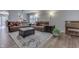 Spacious living room featuring comfortable sofas, a patterned rug, and natural light at 10510 Mcclain Dr, Brownsburg, IN 46112