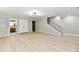 Spacious finished basement features wood-look floors, recessed lighting, and access to the bathroom and staircase at 1053 Millwood Ct # 3, Indianapolis, IN 46260