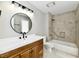 Updated bathroom with granite vanity, modern fixtures, and a tiled tub-shower combo at 1053 Millwood Ct # 3, Indianapolis, IN 46260