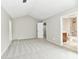 Spacious bedroom featuring neutral colors, vaulted ceilings, and access to a full bathroom at 1053 Millwood Ct # 3, Indianapolis, IN 46260