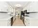Eat-in kitchen featuring new stainless steel appliances, stone countertops, and white cabinets at 1053 Millwood Ct # 3, Indianapolis, IN 46260