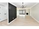 Spacious living room with fireplace, modern light fixture, and vinyl floors at 1053 Millwood Ct # 3, Indianapolis, IN 46260