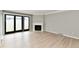 Living room with fireplace, back door, and new vinyl floors at 1053 Millwood Ct # 3, Indianapolis, IN 46260
