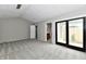 Open primary bedroom with new carpet, neutral paint, and access to private patio at 1053 Millwood Ct # 3, Indianapolis, IN 46260