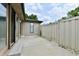 Enclosed patio area with neutral siding, privacy fence and sliding door at 1053 Millwood Ct # 3, Indianapolis, IN 46260