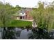Aerial view of estate home featuring lush landscaping, serene pond, and charming gazebo at 1188 Old Eagle Way, Greenwood, IN 46143