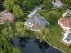 Aerial shot of a home overlooking a pond, showcasing its well-maintained landscaping at 1188 Old Eagle Way, Greenwood, IN 46143