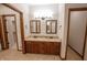 Elegant bathroom with double sinks, granite countertop, and decorative mirrors, offering a touch of luxury at 1188 Old Eagle Way, Greenwood, IN 46143