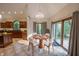 Bright dining area with a round table, chandelier, and sliding glass doors to the exterior at 1188 Old Eagle Way, Greenwood, IN 46143
