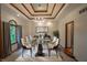 Elegant dining room features a glass table, coffered ceilings, and sophisticated decor at 1188 Old Eagle Way, Greenwood, IN 46143