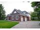 Expansive two-story home with brick and vinyl siding, attached garages, and lush green landscaping at 1188 Old Eagle Way, Greenwood, IN 46143