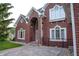 A brick front entrance highlighted by arched windows and a patterned stone walkway to the front door at 1188 Old Eagle Way, Greenwood, IN 46143