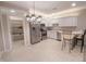 Charming kitchen featuring stainless appliances, white cabinets, and a stylish chandelier at 1188 Old Eagle Way, Greenwood, IN 46143