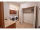 Functional laundry room with modern washer and dryer, granite countertop, and additional storage space at 1188 Old Eagle Way, Greenwood, IN 46143