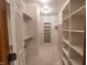 Bright walk-in closet with built-in shelves and hanging rods, maximizing storage and organization at 1188 Old Eagle Way, Greenwood, IN 46143