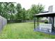 Backyard featuring a large grassy area with a bench seat and a patio with hanging seat at 12157 Longstraw Dr, Indianapolis, IN 46236