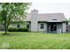 Backyard featuring large grassy area, privacy fence, patio, and the rear of the home at 12157 Longstraw Dr, Indianapolis, IN 46236