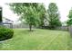 Spacious backyard featuring a well-maintained lawn, mature trees, and a privacy fence at 12157 Longstraw Dr, Indianapolis, IN 46236